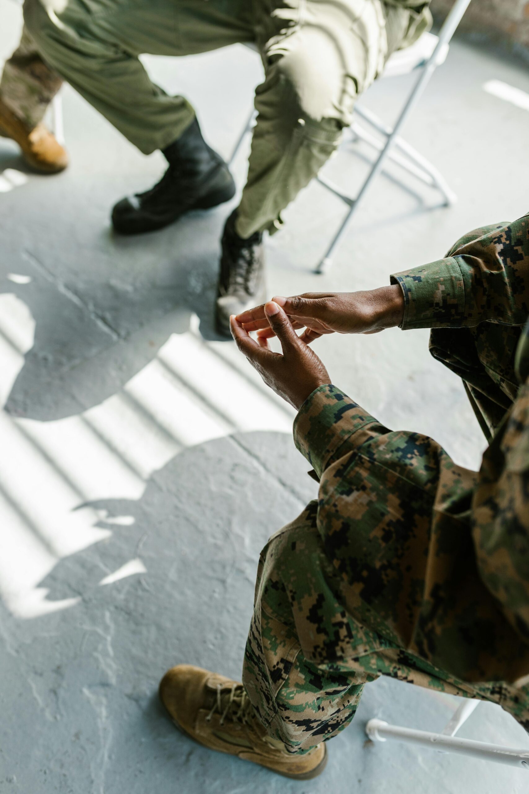 Soldiers engage in group therapy, fostering support and mental health in an indoor setting.